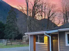 Cottage exterior at sunset with Mount Si behind